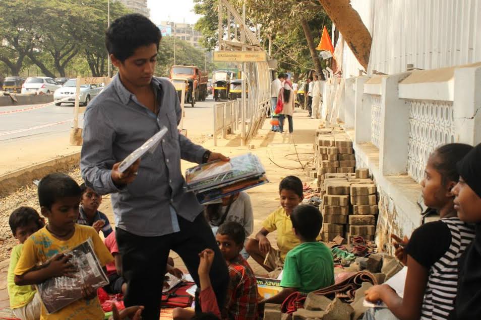 Siddhant Mohite distributing books among kids during their Ab Padega India initiative